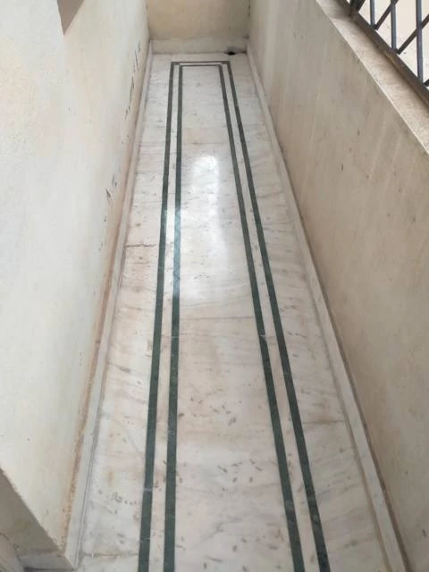 Polished marble corridor with dark inlay lines